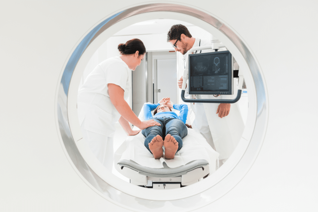 Radiology technicians talk to patient before MRI.