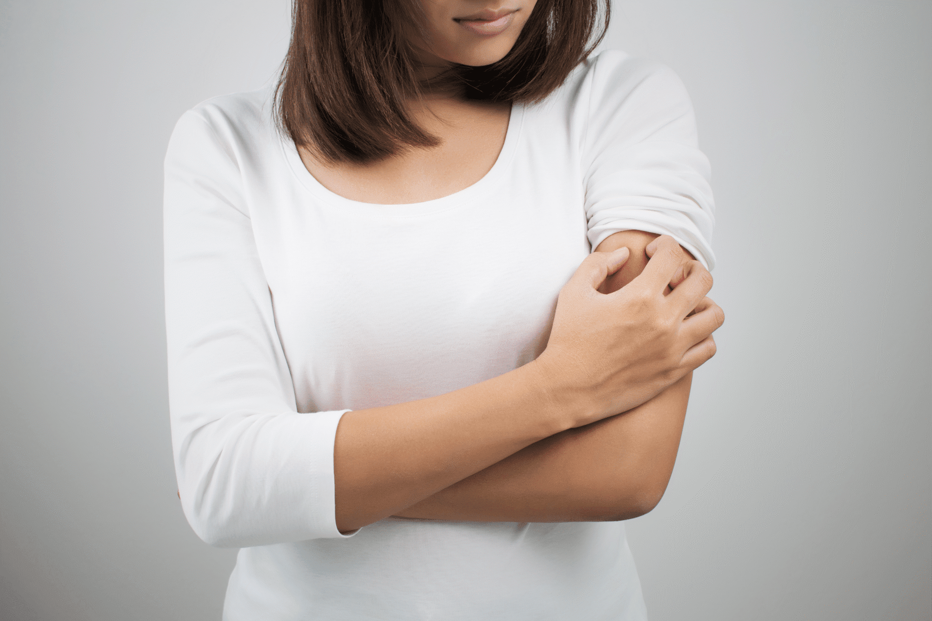 Woman scratching tick bite.