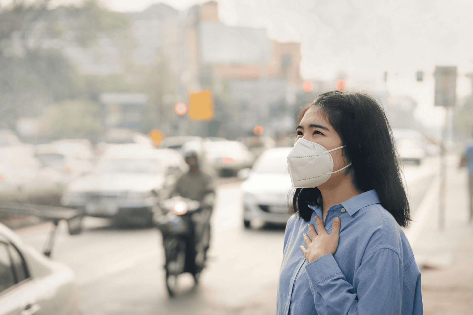 lady with mask on outside due to poor air quality